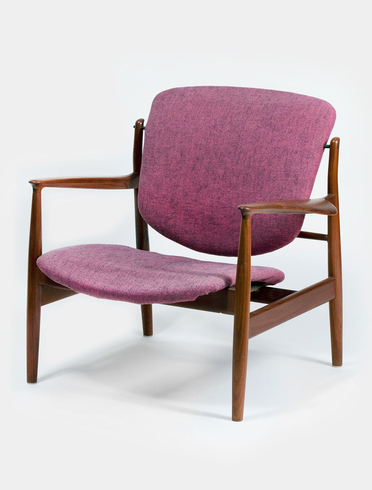 Carved teak and fabric armchair Model 136 by Scandinavian Finn Juhl. Retains its original mauve wool fabric, but does need new foam and possibly strapping. The chair is in otherwise exceptional all original condition. Signed with a metal tag 