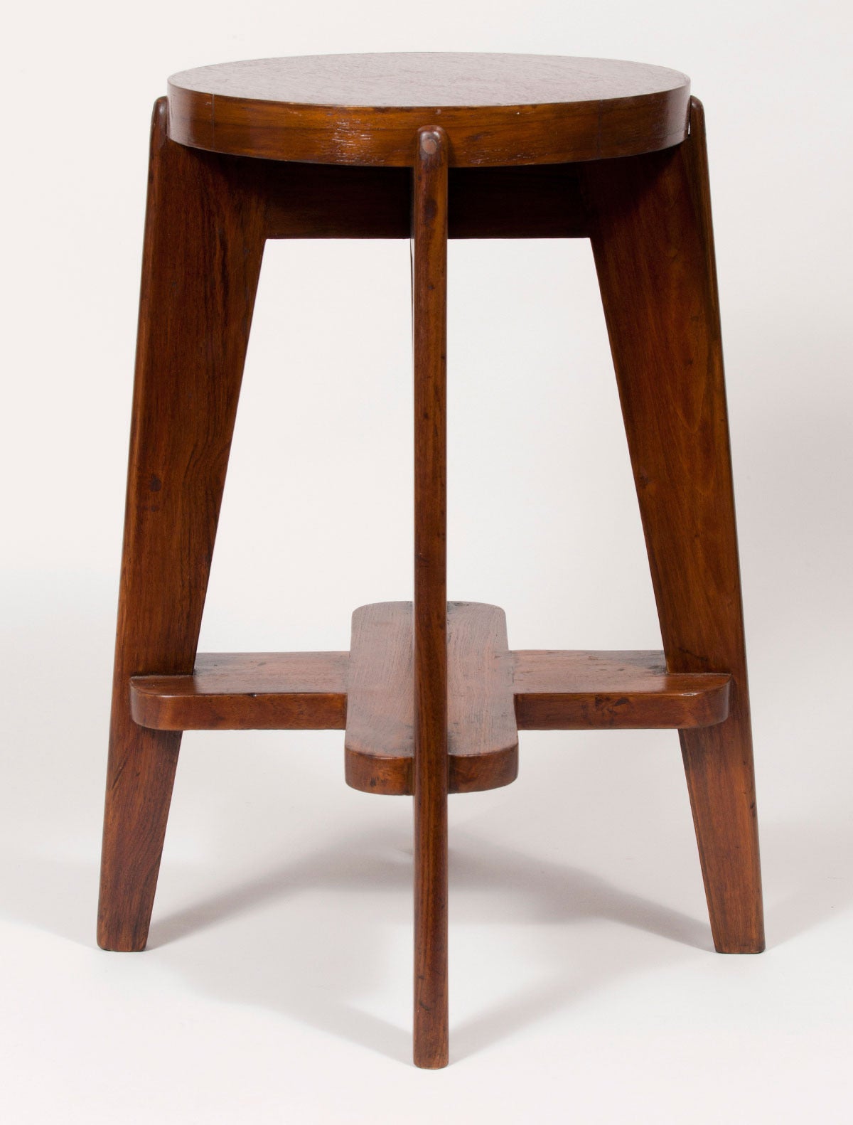 Solid teak stool by the Swiss architect Pierre Jeanneret. From the Modernist city Chandigarh, India which he designed with his cousin Le Corbusier. One available.