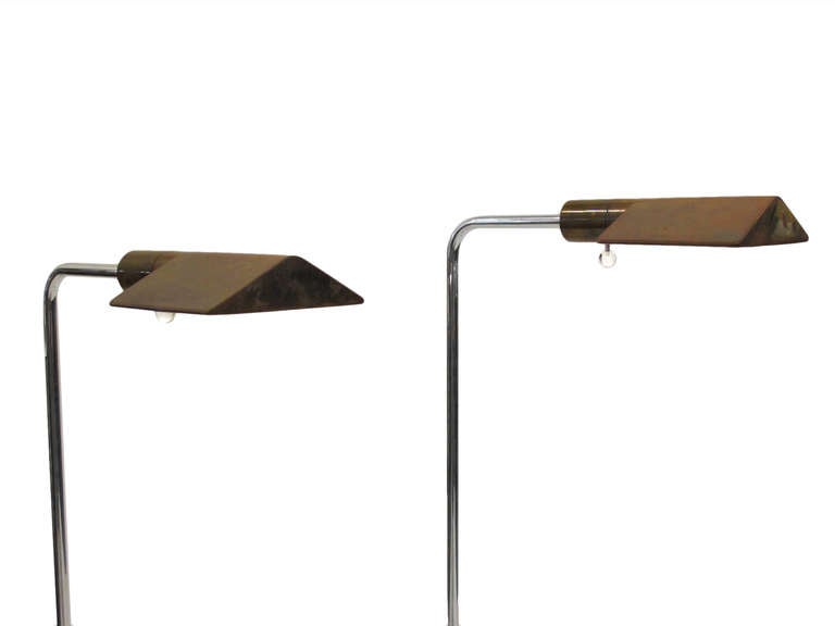 Early pair of brass and aluminum adjustable floor lamps by Cedric Hartman. Signed.