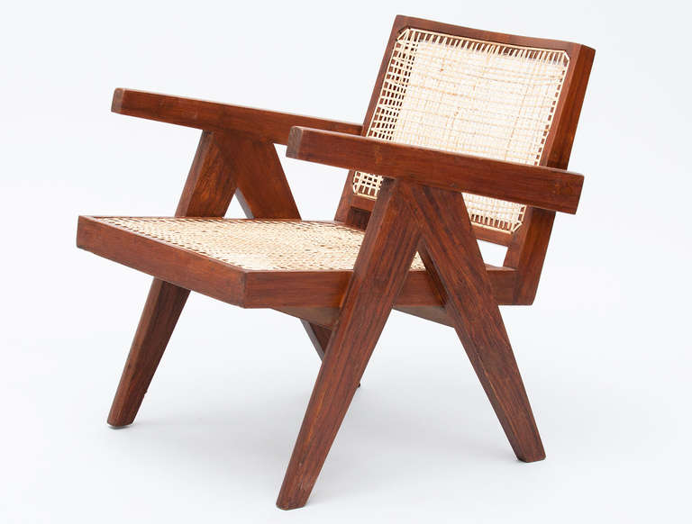 Rare low lounge chairs in teak and cane designed by Pierre Jeanneret for the famous modernist capital city of Chandigarh which was entirely designed by Le Corbusier and Jeanneret. 4 pieces available.