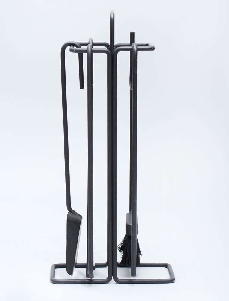 Unusual and graphic painted iron five piece fire tool set.