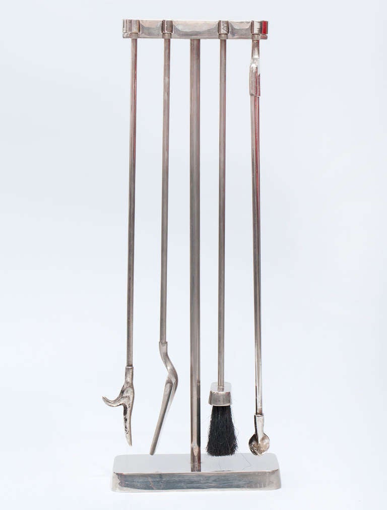 Interesting nickel-plated interlocking four piece fire tool set by an anonymous American designer.