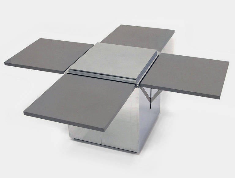 Unique lacquered and polished steel custom coffee table with four adjustable pop-up leaves. Attributed to Karl Springer Studios of NYC.