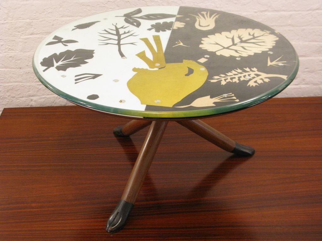 Possibly unique glass and carved wood tripod table by the revered Italian firm. Top consists of 2 layers of glass, clear, black and white with gold and silver decoration inspired by Matisse. Documented in L'Arredomento Moderno by Roberto Aloi