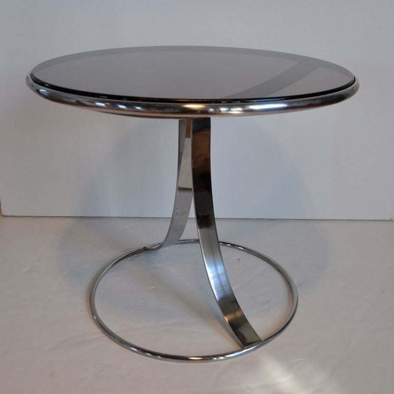 Pair of solid polished steel side tables with inset smoked glass tops.