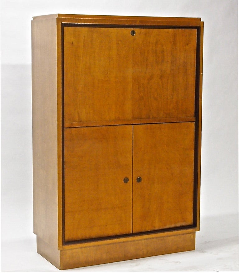 Secretary, chest with a drop front and two lower doors that open to reveal a polished mahogany interior. Images five, six, and seven show the piece's interior drawers and shelves. 
