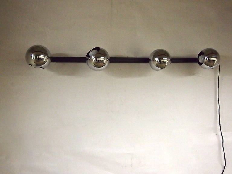 Eight chrome plated round lights by Lightolier. The tracks can be wall or ceiling mounted. The lights clip in and can be articulated to spot in any desired direction. Each light also slides along the track for various positioning options.