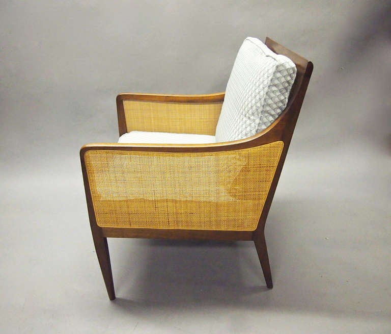 A single chair in excellent vintage condition by Kipp Stewart for Directional. The chair is caned on both sides and in the back. The caning is perfect condition. There are two cushions: The bottom seat is attached to the chair and the back cushion