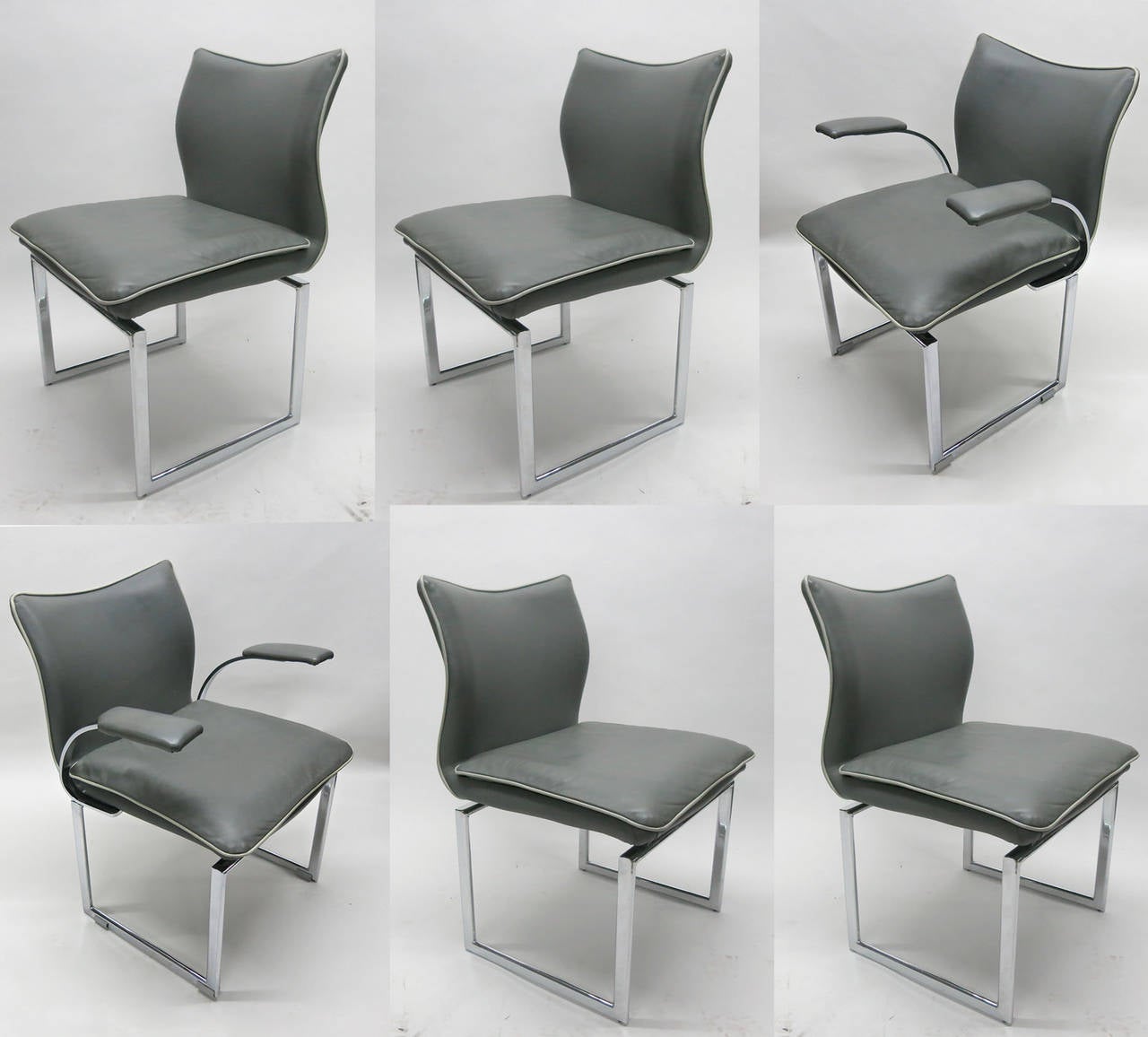 Two arm and four side chairs each have grey leather seats and back with white stitching, In near perfect original Condition, supported by a polished steel base. Two with ams and four with out.