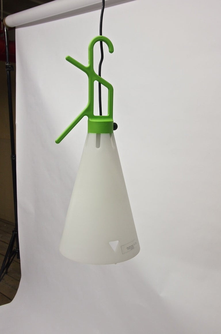 Ten utility lights fixtures each with a tapered white diffuser made of polypropylene a Hook/Handle in green polypropylene also acts as a cord winder with a black on off switch attached.