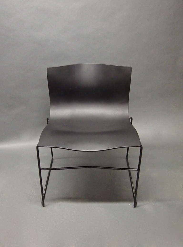 A dozen handkerchief chairs original design came in 1983 by Lella and Massimo Vignelli a wind blown handkerchief was the idea. The chairs have an enameled tubular base and a black polyurethane seat. They stack for easy and practical storage.