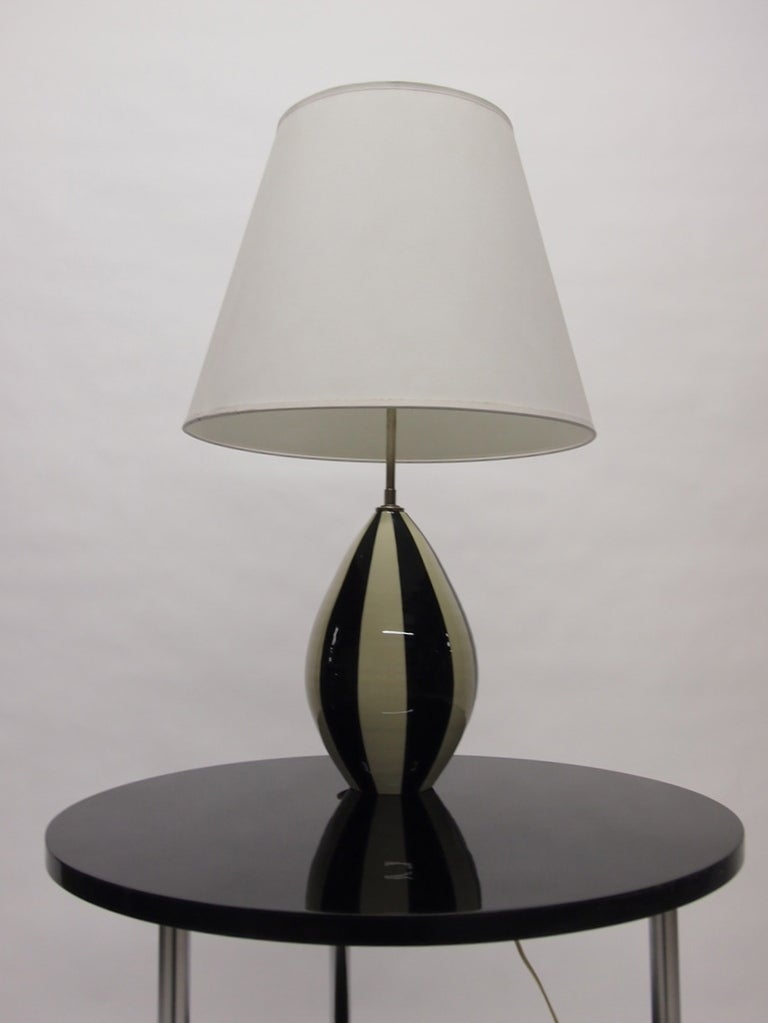 Pair of black and white ceramic table lamps. The lamps stand 26