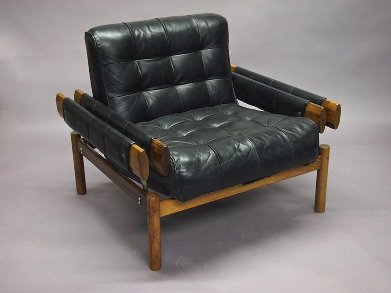Chair with Ottoman by Percival Lafer with tufted black leather and Jacaranda wood, all in original condition. 

Ottoman Measurements: 
Height: 15 inches
Width: 29 inches
Depth: 21 inches