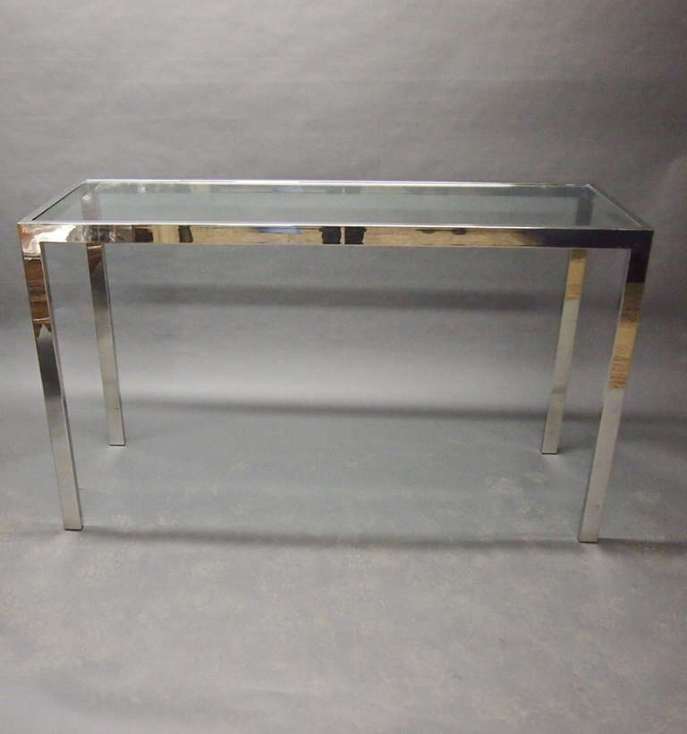 Console in seamless polished steel with an inset glass top designed by Rosen for Pace.