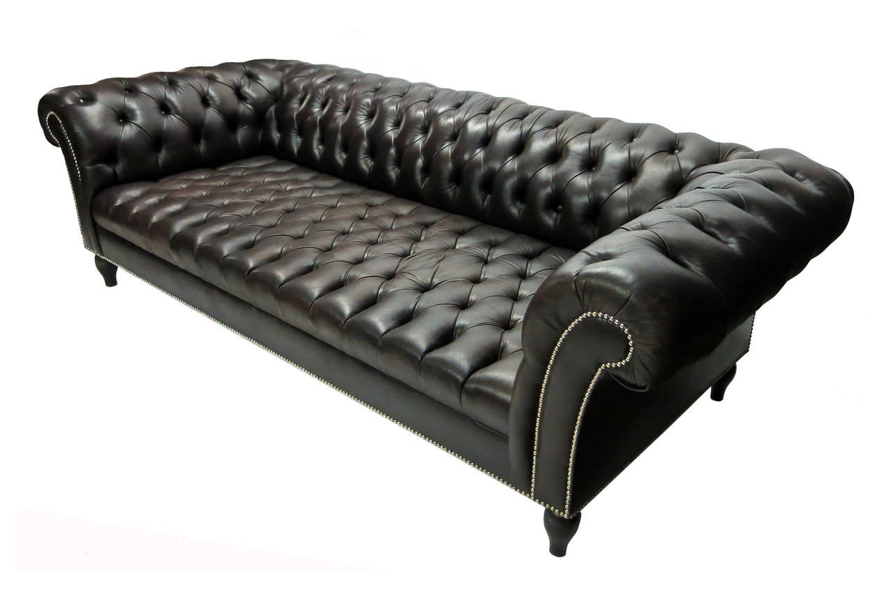 Chesterfield sofa in chocolate brown leather deep seat and large rounded arms trimmed with nailheads.