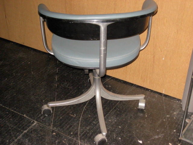 Pair of rolling adjustable desk chairs in cast aluminum and upholstered in a grey/blue leather. The chairs are signed and dated underneath and in very good condition.