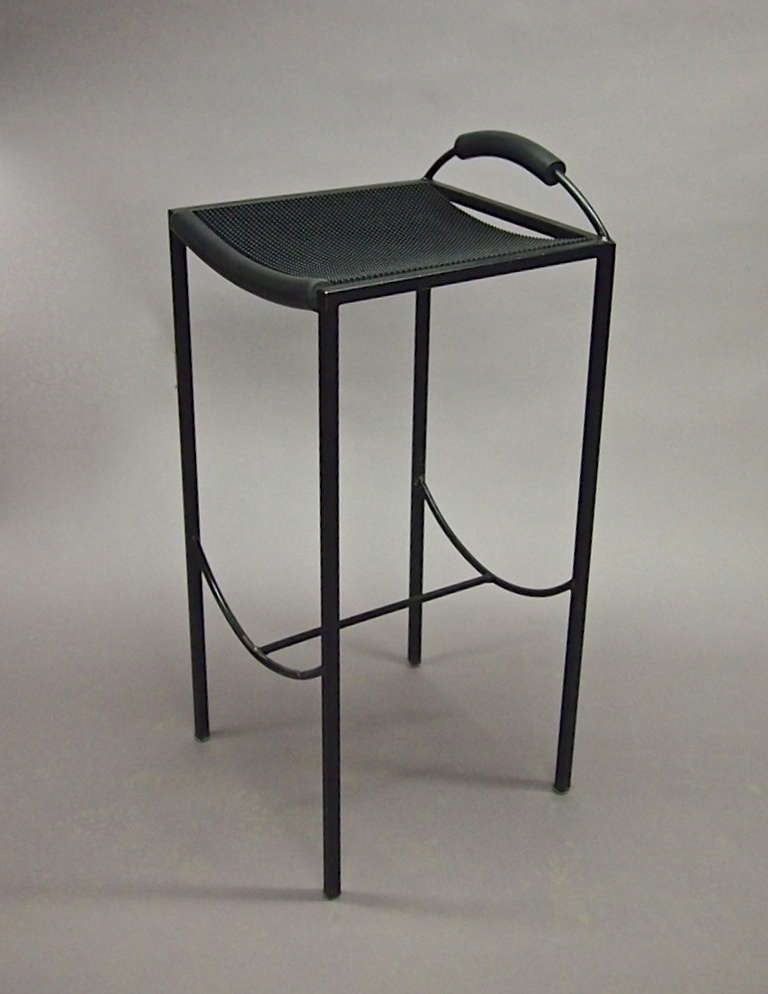 Set of four 'Sgabello' stools in black enameled metal with a slightly curved seat that is covered in a textured rubber. 