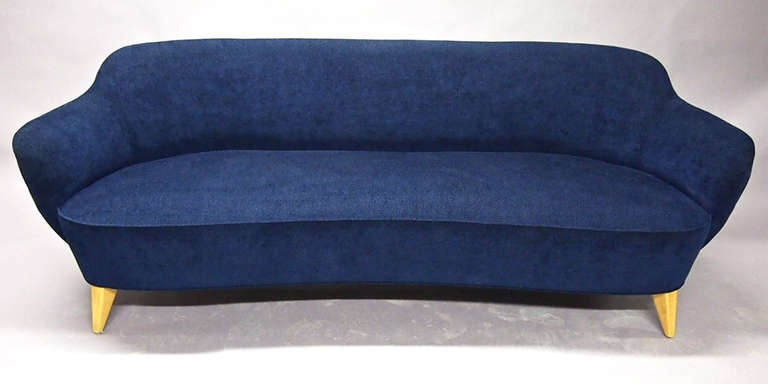 The Barrel Sofa has rounded back and arms with slightly arched seat all newly upholstered in a blue woven, pile fabric.