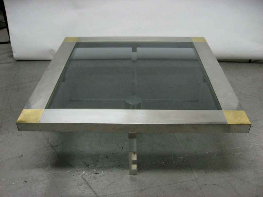 Coffee Table with a acrylic base and inset smoked glass top that is framed in brushed steel with brass corners. Table is signed.