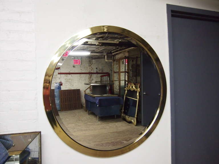 Round Mirror with a beveled edge trimmed with 2 inch brass