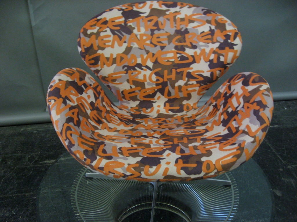 SWAN chair designed by Arne Jacobsen in a Stephen Sprouse for KnollTextiles fabric (Graffiti Camo, 2003, ID# 2767) of camouflage design with Sprouse's lettering of the US's Declaration of Independence. Sprouse did five fabric surface designs for