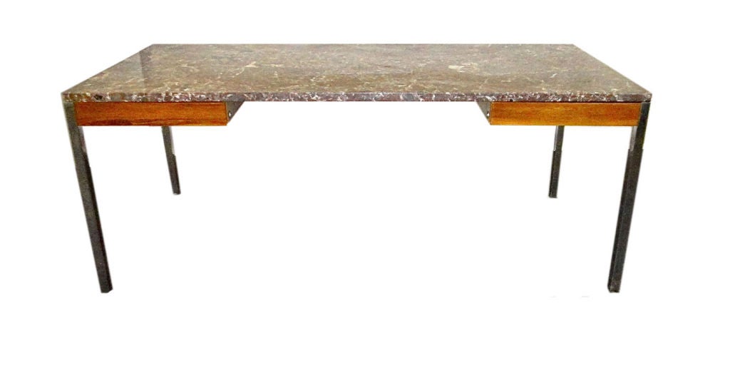 Der Schreibtisch hat einen massiven Rahmen aus poliertem Stahl, der eine 1,25 Zoll große Marmorplatte mit dünnen Holzschubladen auf jeder Seite trägt. Der Schreibtisch wurde in den 1960er Jahren für das Corporate Office der Chase Bank in NYC