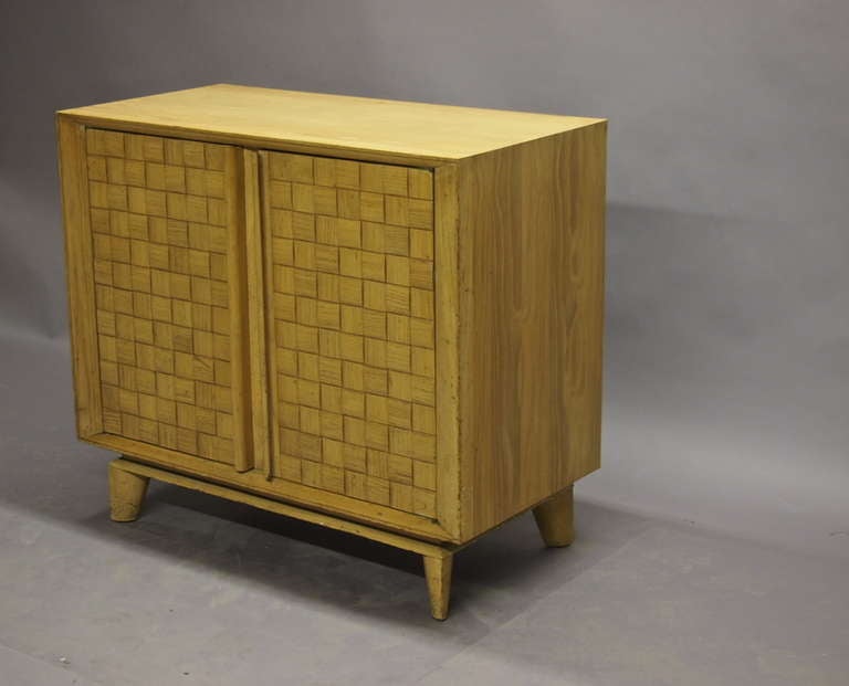 Cabinet signed Brown Saltman with wooden doors in a basket weave pattern. The piece opens to shelves.