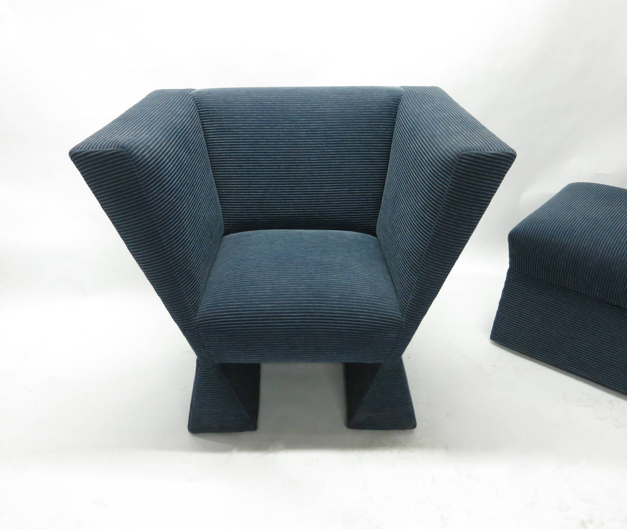 Chair and ottoman have a geometric angular design with a V-Form both covered in a blue fabric. The design and fabrication all done custom in 1982.
