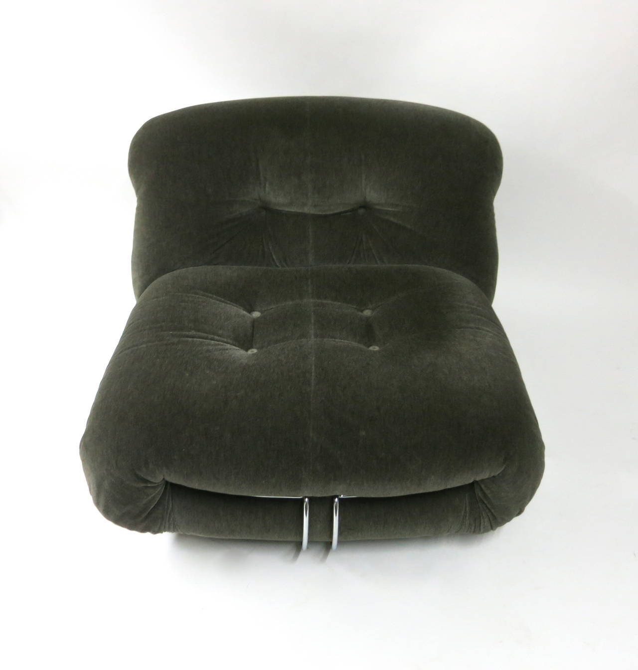 Chair with ottoman in original dark grey fabric. The chair has original casters on the back and feet in the front. The ottoman has all four original casters. Set was well cared for some very minor scuffs on the fabric. If you like original vintage