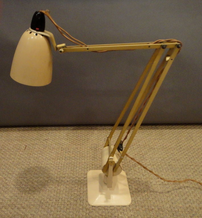 Articulating desk lamp in enameled metal swivels at base is made by Hadrill and Horstmann in England in 1930's