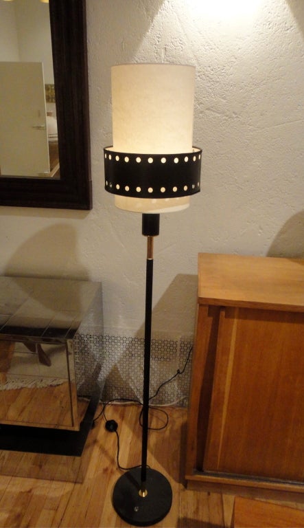 Floor lamp by Jaques Adnet in black enameled metal and brass.