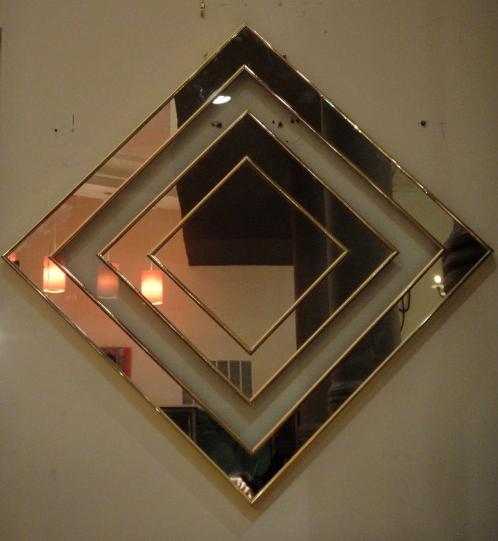 Mirror trimmed in brass with hardware to be hung as shown or as a square.