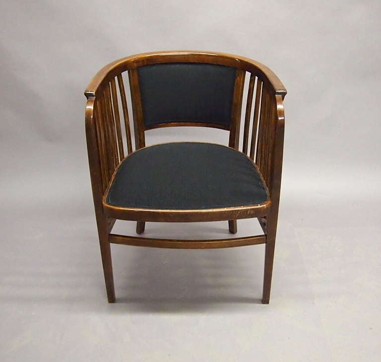Arm chair by Marcel Krammerer in beachwood with a slatted round back an an upholstered seat. The back is supported on four arched tapered legs.