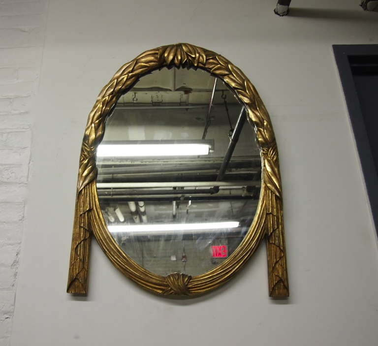 Mirror in hand carved wood and gold appliqué in very good, original condition.