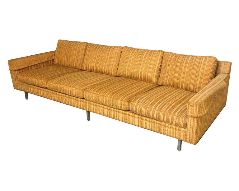 Sofa in original fabric with four seat and back cushions supported by six one inch square polished steal legs