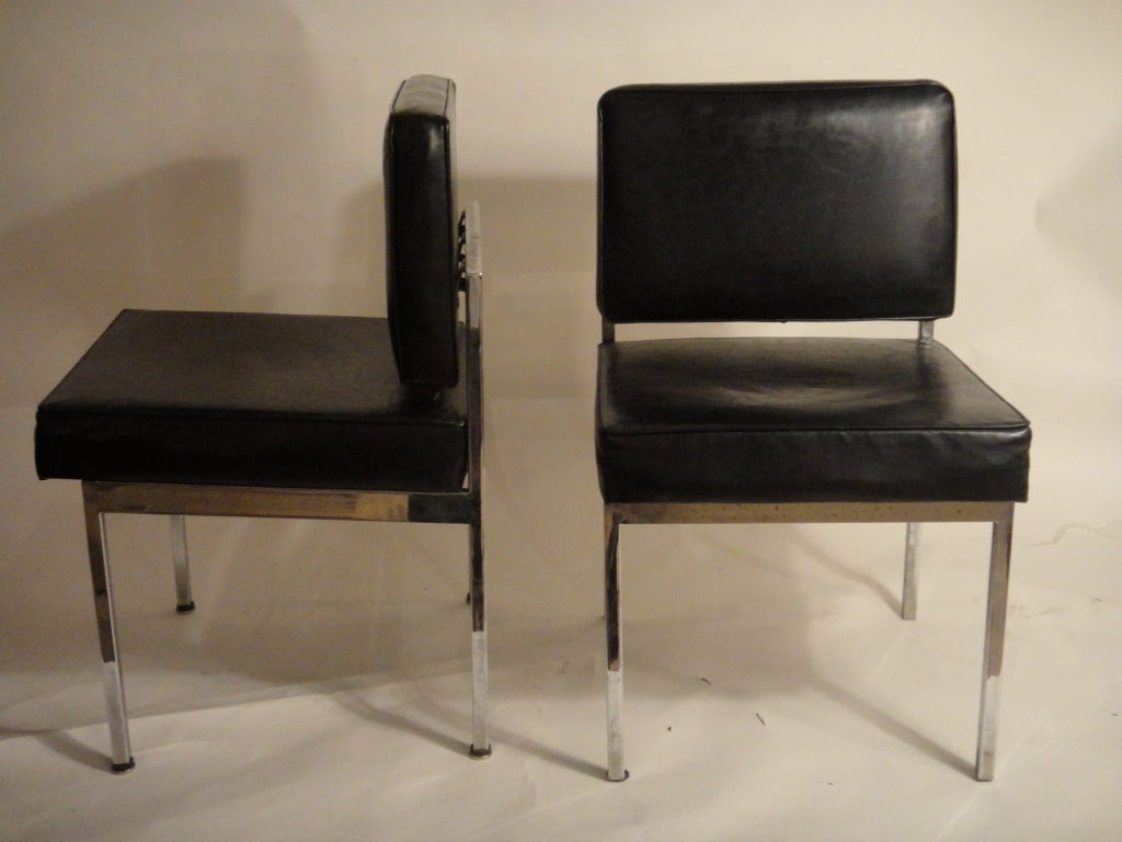 Pair of chairs in black leather and polished steel frame