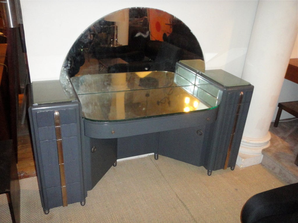 Vanity lacquered with silvered pulls, gilt metal handles, mirrored top and thick frosted glass that lights