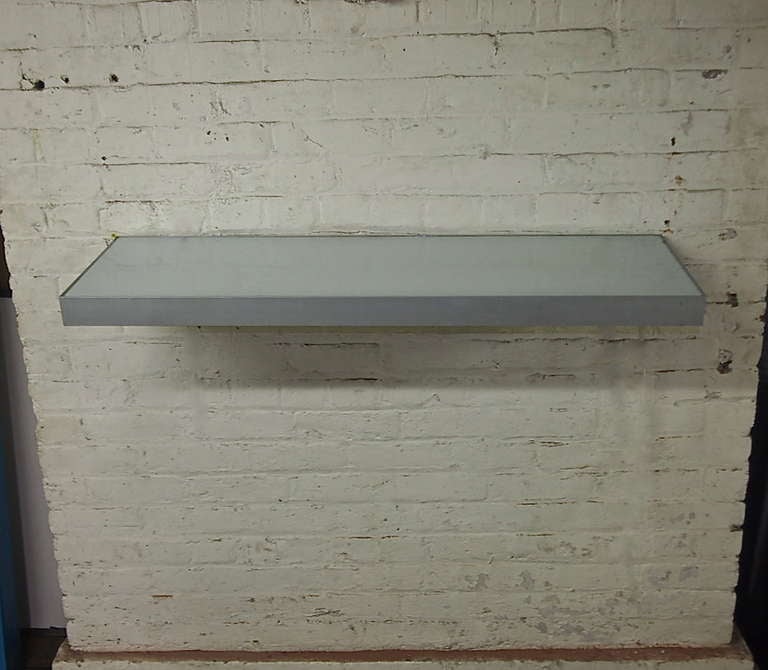 Console with frosted glass top and bottom with lights signed on the side