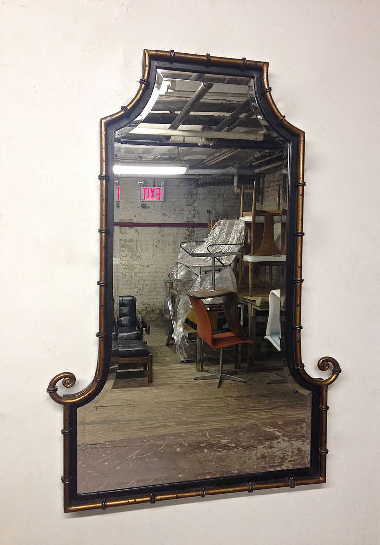 Beveled Mirror with hand crafted faux bamboo detail in gold enamel over a black enameled steel frame.