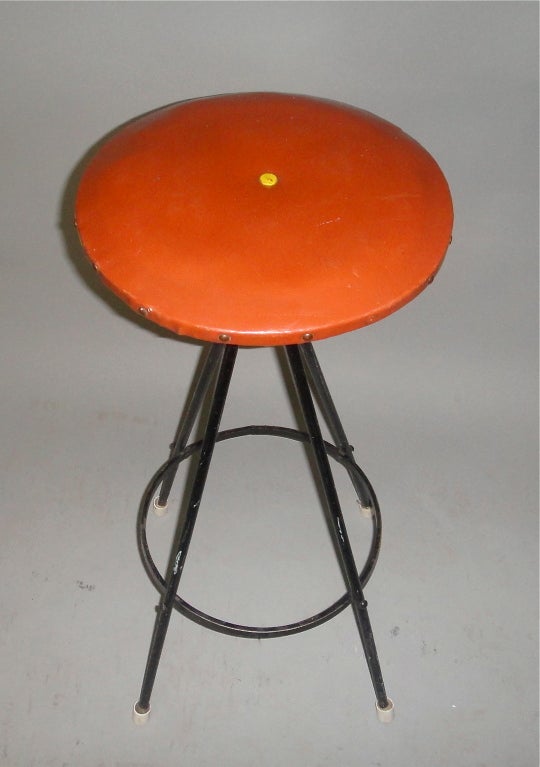 Set of three stools with black Enameled iron base that supports round brown vinyl seats with brass nail heads around the sides and  yellow buttons in the center