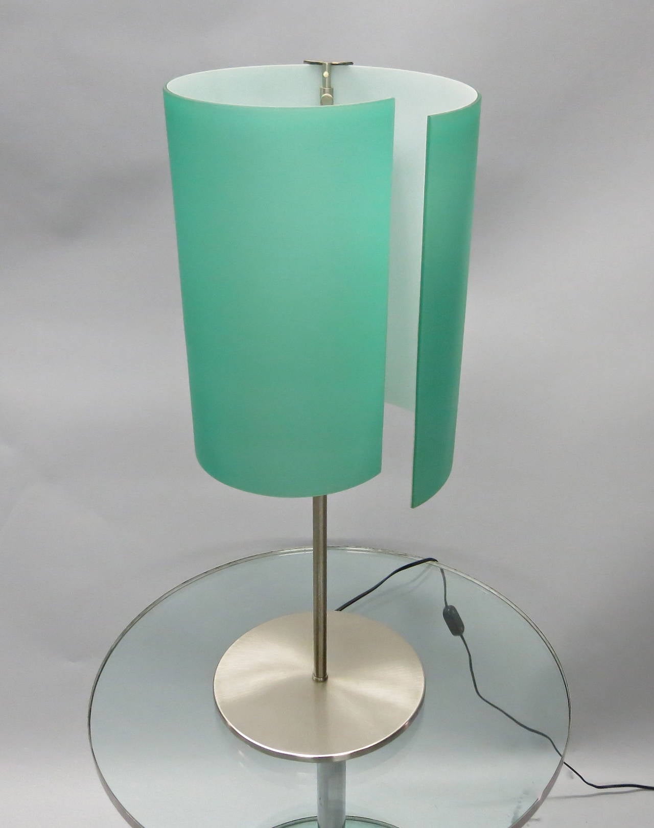 Table lamp in curved, hand made, satin aqua-colored cased glass and brushed nickel; labeled "Leucos Fatto A Mano Made in Italy." In excellent condition- no scratches or chips. This color shade is no longer offered by Leucos.