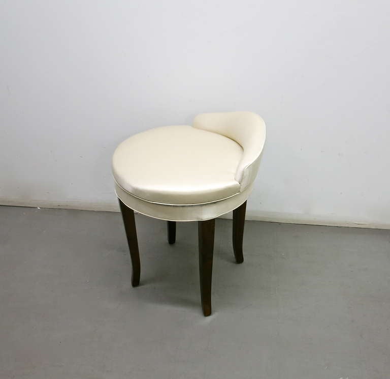 Stool by Samuel Marx with a swivel seat and a small upholstered back all in satin and supported on four arched, wooden legs.
