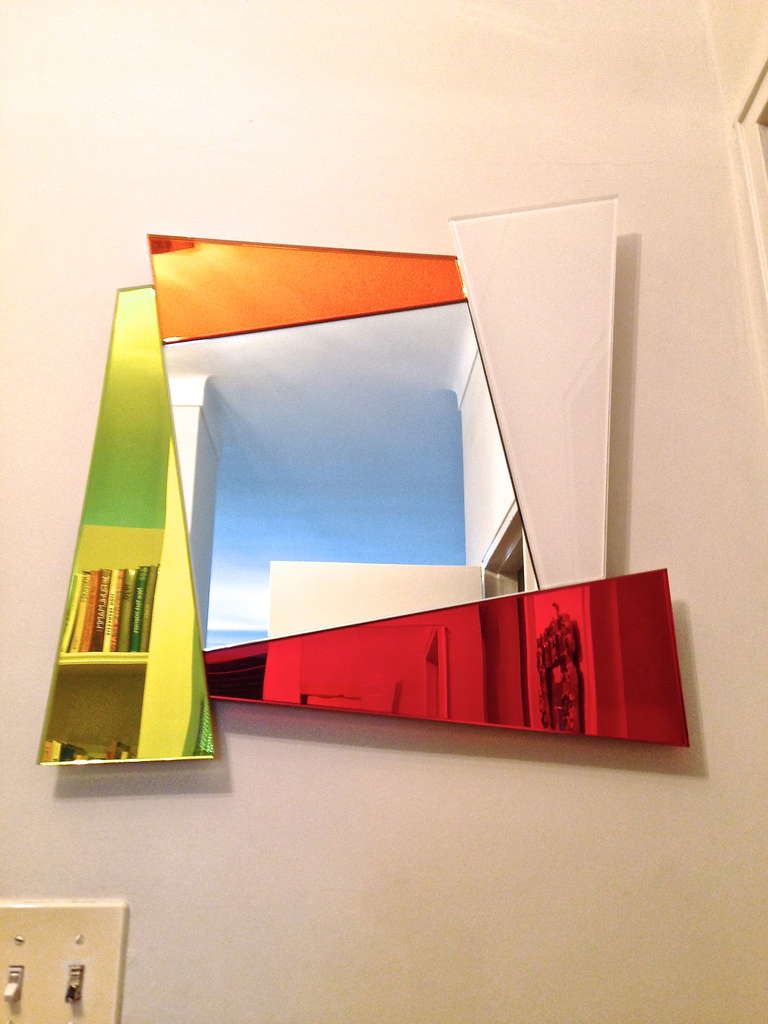 Mirror surrounded by geometric colored mirror designed by Ettore Sotsass.