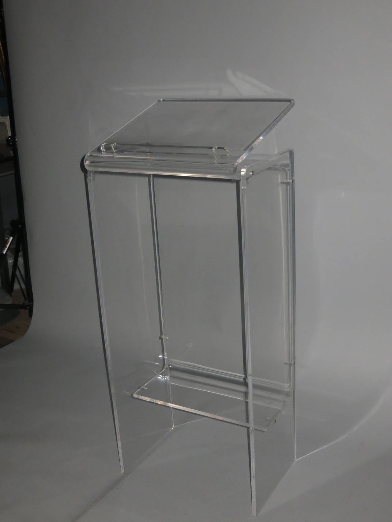 Well kept acrylic Podium is all Lucite bonded with counter sunk screws. The top angles up for reading material or book. Perfect for restaurant Reservations or Music stand. The condition is amazing practically without a scratch

Made in USA