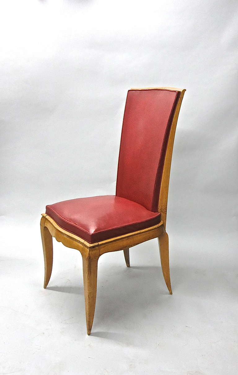 Six Dining Chairs with high arched back tapered arched legs front and back in original red leather that covers the seat and both sides of the back