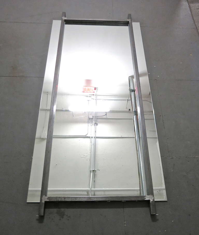 Pair of 11 foot tall mirrors with a steel frame in front of the mirror that is flush with the horizontal frame at the top and bottom. The mirror is 5