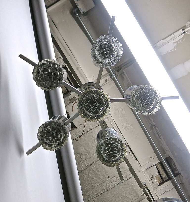 Ceiling fixture with five original glass diffusers that lock into a tubular chrome frame each connected by a rectangular brushed aluminum bar that enclose the wiring.