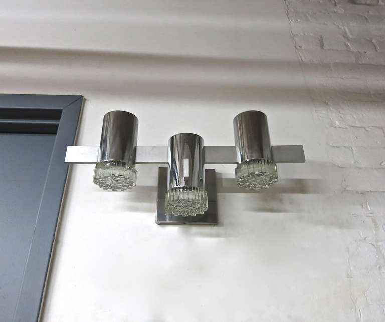 Pair of Sciolari sconces each with three, original glass diffusers that screw into a chromed frame that is connected by a rectangular brushed aluminium bar, concealing the wires. Made in Italy wiring has been upgraded to American candelabra each