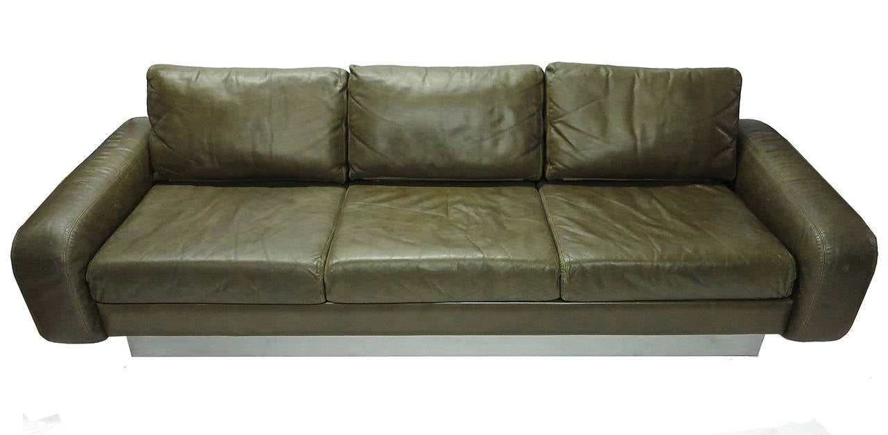 Sofa has three-seat cushions and back pillows that sit between two large floating arms all in original leather resting on a base of polished steel over wood. 
Strong well made sofa with a great design all original. No repairs and no damage 
very