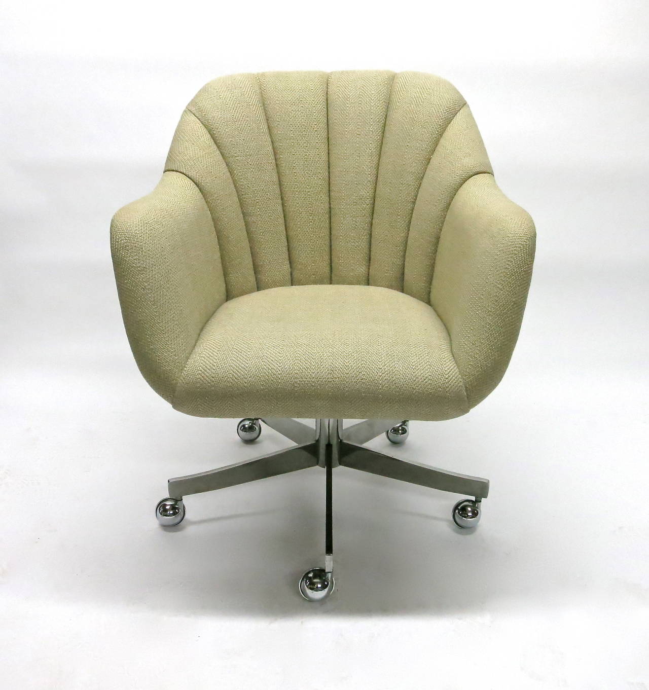 Swiveling desk chair in original fabric and on castors. There are three labels underneath and one property tag attached. The chair was the property of VAH and purchased from Brickell in 1984. Image #9 shows the standard red label of Ward Bennett for
